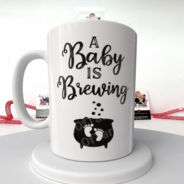 White mug with 'A Baby is Brewing' design